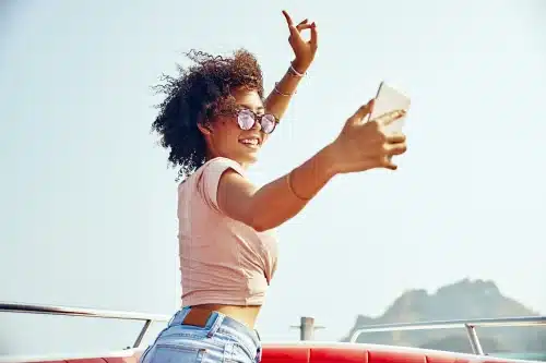 smiling young woman taking selfies on a boat 2023 11 27 05 26 13 utc